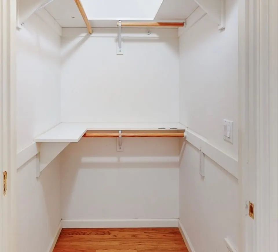 The closet before the remodel, with a single shelf and rod
