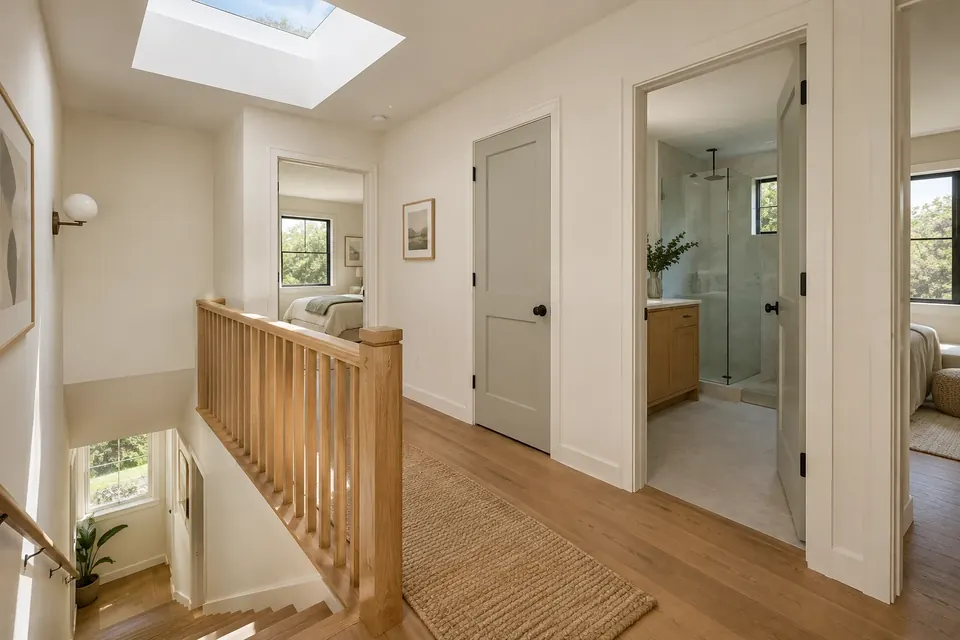 Illustration: a light-filled second-floor landing with a wooden stair railing and bedroom doors